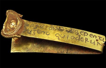 A piece of gold containing biblical inscriptions in Latin.