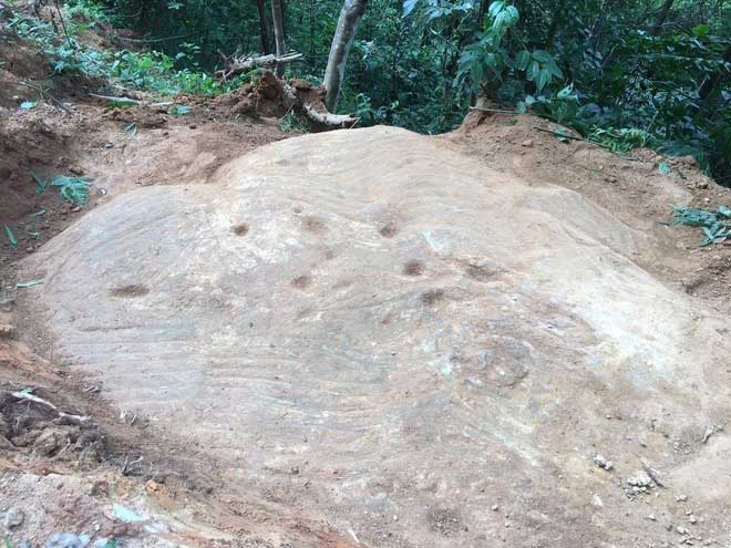 Ancient stone block carved with terraced fields in Mù Cang Chải.
