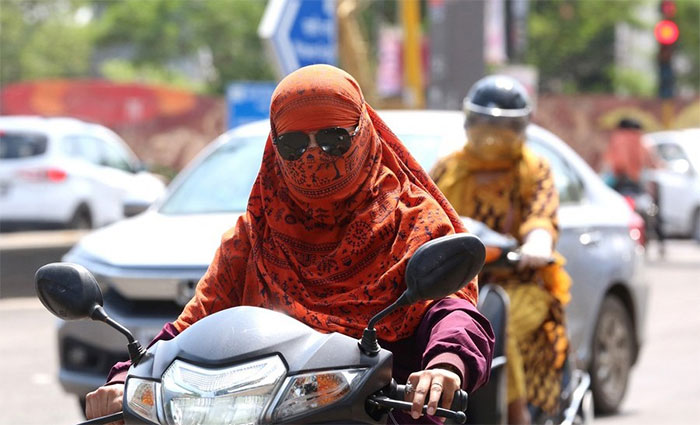 Người dân di chuyển trên đường phố dưới trời nắng nóng tại Bhopal, Ấn Độ