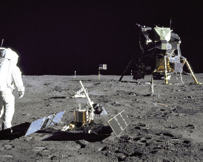 Astronaut Buzz Aldrin examining lunar soil